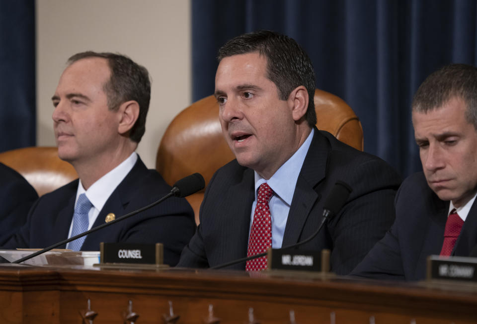 Rep. Devin Nunes, R-Calif, the ranking member of the House Intelligence Committee, center, flanked by Chairman Adam Schiff, D-Calif., left, and Steve Castor, the Republican staff attorney, questions the witnesses during the first public impeachment hearing of President Donald Trump's efforts to tie U.S. aid for Ukraine to investigations of his political opponents, on Capitol Hill in Washington, Wednesday, Nov. 13, 2019. (AP Photo/J. Scott Applewhite)