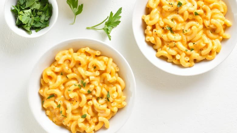 two bowls mac cheese with parsley
