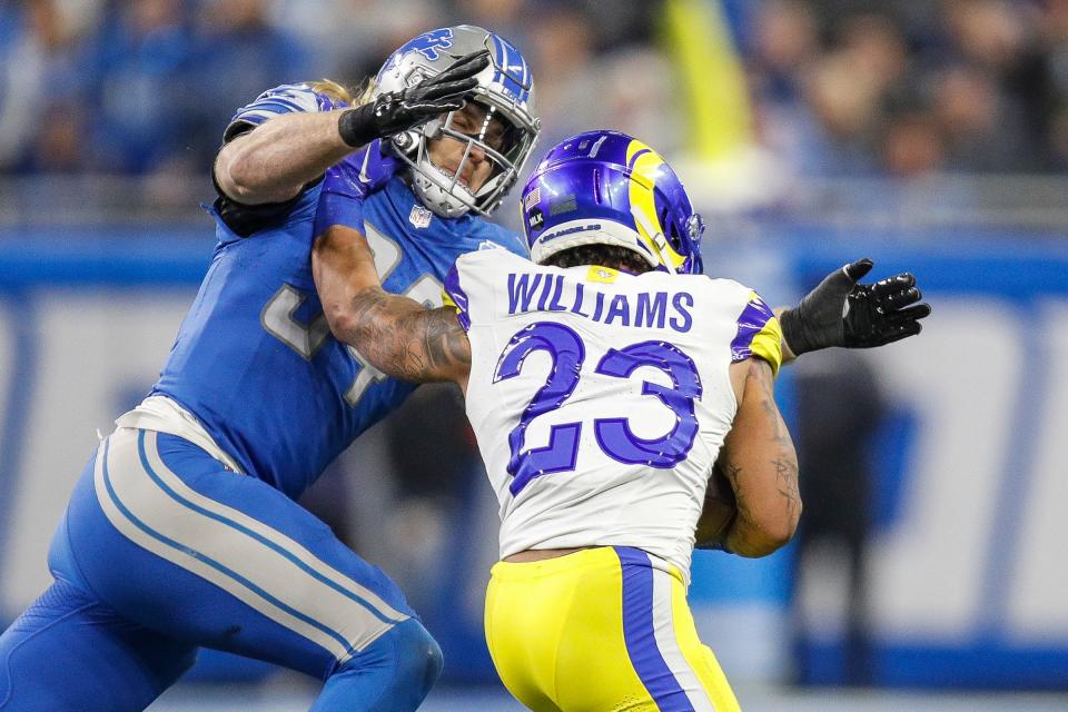 Detroit Lions linebacker Alex Anzalone tackles L.A. Rams running back Kyren Williams during the first half of the NFC wild-card game at Ford Field in Detroit on Sunday, Jan, 14, 2024.