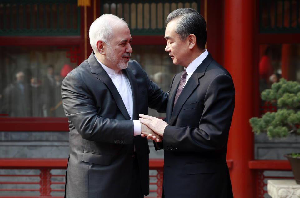 Iranian Foreign Minister Mohammad Javad Zarif, left, and his Chinese counterpart Wang Yi shake hands during their meeting at the Diaoyutai State Guesthouse in Beijing Tuesday, Feb. 19, 2019. (How Hwee Young/Pool Photo via AP)