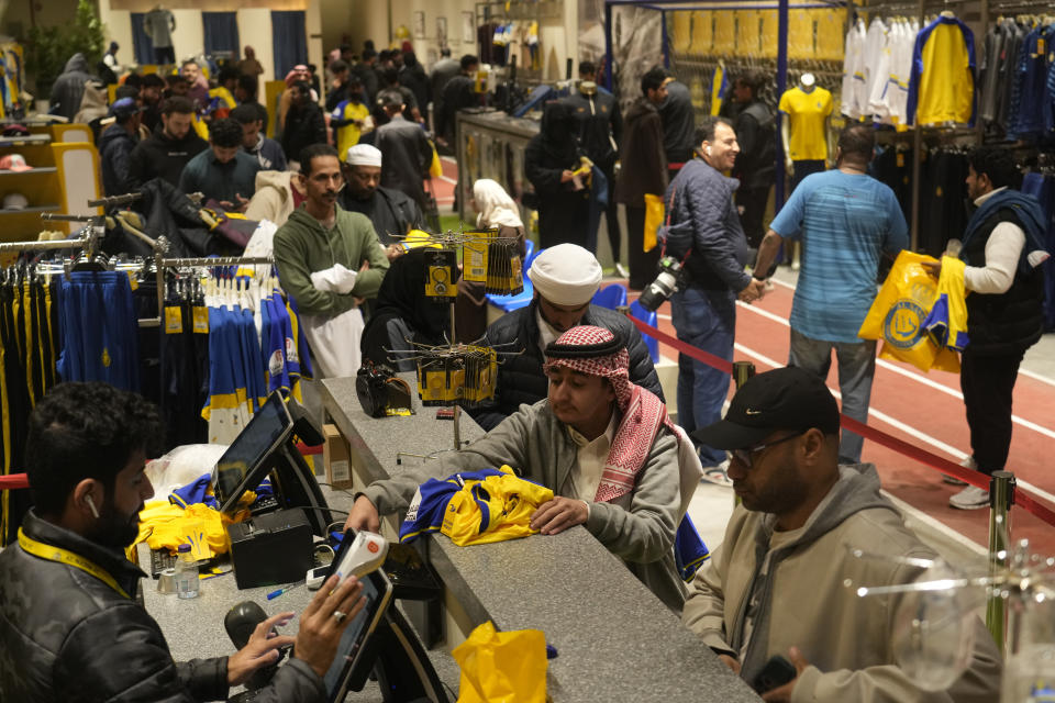 Peopleline up to buy Cristiano Ronaldo jerseys at Al Nassr soccer club store in Riyadh, Saudi Arabia, Monday, Jan 2, 2023. Ronaldo completed a lucrative move to Saudi Arabian club Al Nassr on Friday in a deal that is a landmark moment for Middle Eastern soccer but will see one of Europe's biggest stars disappear from the sport's elite stage. (AP Photo/Amr Nabil)