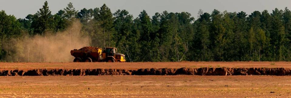 A truck hauls dirt as excavation work continues at the VinFast site.