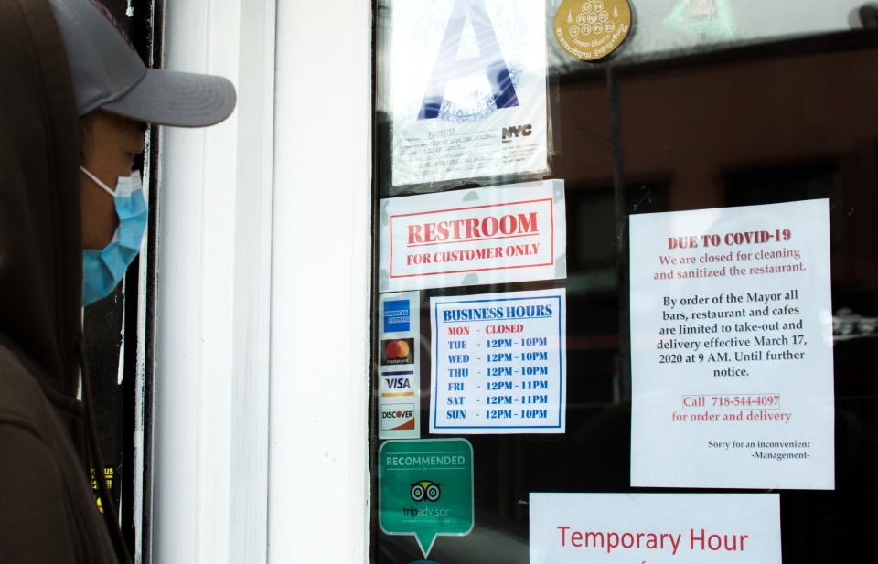 New York City, NY/ USA- 4-05-20: Person Looking at Closed Restaurant Sign Covid19 Coronavirus Pandemic Lockdown