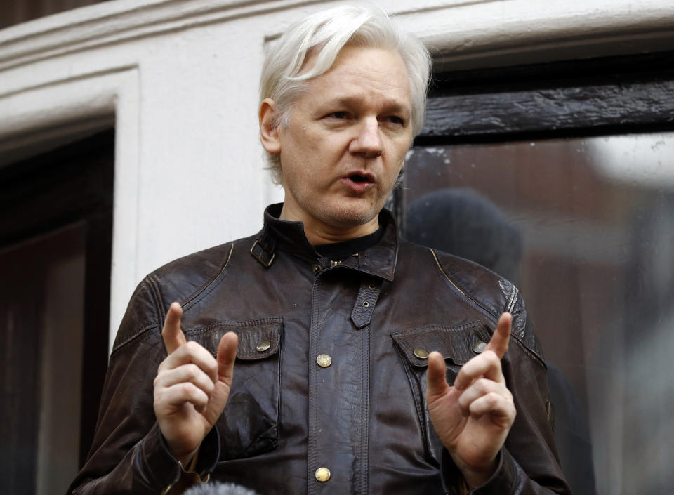 FILE - In this May 19, 2017 file photo, WikiLeaks founder Julian Assange gestures to supporters outside the Ecuadorian embassy in London, where he has been in self imposed exile since 2012. (AP Photo/Frank Augstein, File)