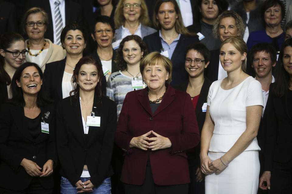 FILE - In this Wednesday, Oct. 19, 2016 file photo, German Chancellor Angela Merkel poses with women after a conference with women in leadership at the chancellery in Berlin. Millions of women admire the 67-year-old for breaking through the glass ceiling of male dominance in politics, and she’s been lauded as an impressive role model for girls both at home and around the globe. (AP Photo/Markus Schreiber, File)