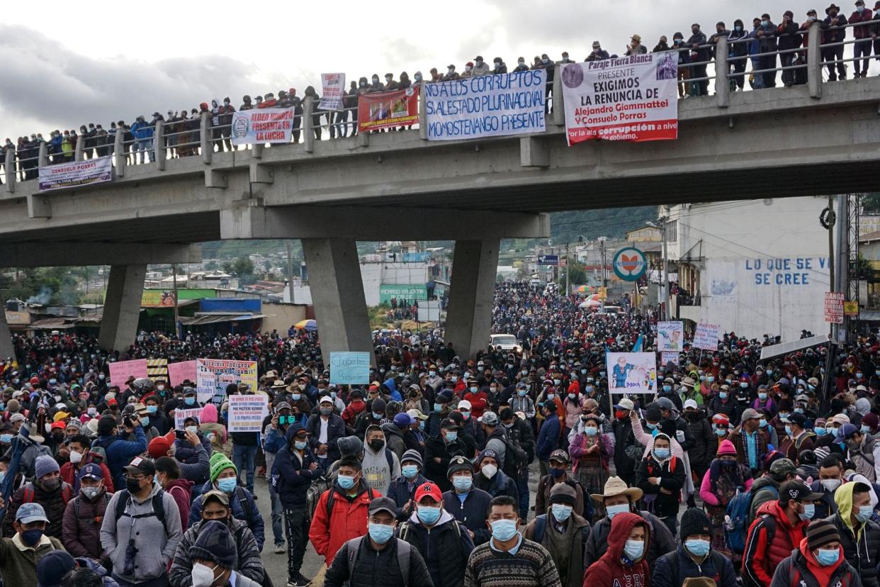 TOPSHOT - Indigenous people block a road demanding the resignation of Guatemalan President Alejandro Giammattei and Guatemala's Attorney General Consuelo Porras after Guatemala's Special Prosecutor against Impunity Juan Francisco Sandoval was dismissed, in Cuatro Caminos, San Cristobal Totonicapan, Guatemala, on July 29, 2021. (Photo by Johan ORDONEZ / AFP) (Photo by JOHAN ORDONEZ/AFP via Getty Images) ORG XMIT: 0 ORIG FILE ID: AFP_9HB73M.jpg