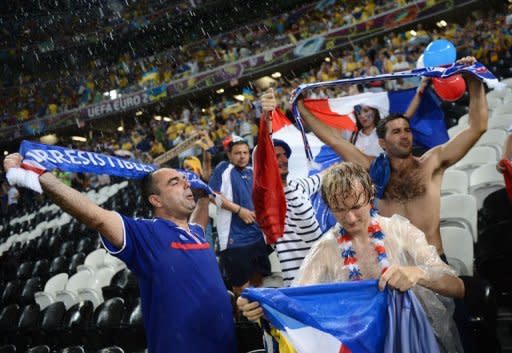 Fans of France's national team are undeterred by the rain at the Euro 2012 in Donetsk. France won 2-0