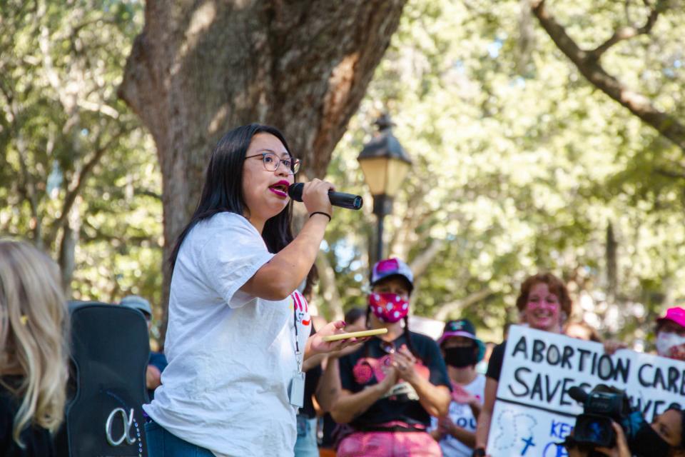 Migrant Equity Organizer Daniela Rodriguez speaks to crowd during the Women's March held at Forsyth Park.