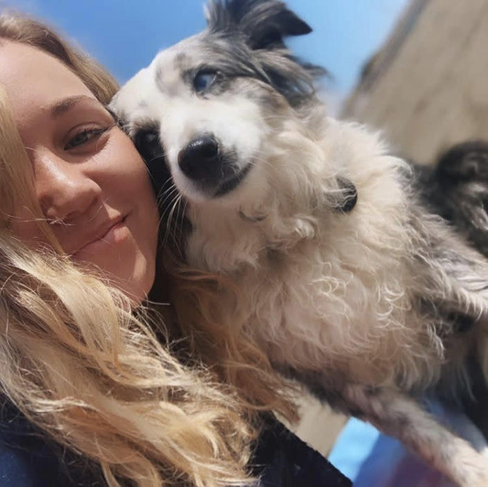 This undated selfie photo provided by Emilie Talermo showing Emilie Talermo and her dog Jackson taken in San Francisco, Calif. Talermo, is offering a $7,000 reward for her blue-eyed miniature Australian Shepherd stolen from outside a grocery store. She has hired a plane to fly a banner over the city. Talermo said Thursday, Dec. 19, 2019, she has been doing everything she can to find her dog, since it was stolen Saturday, Dec. 14, 2019, outside a grocery store in the Bernal Heights neighborhood. (Emilie Talermo via AP)