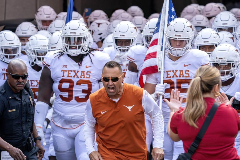 Texas head coach Steve Sarkisian leads his team onto the field before a game against <a class="link " href="https://sports.yahoo.com/ncaaf/teams/oklahoma/" data-i13n="sec:content-canvas;subsec:anchor_text;elm:context_link" data-ylk="slk:Oklahoma;sec:content-canvas;subsec:anchor_text;elm:context_link;itc:0">Oklahoma</a> at the Cotton Bowl, Saturday, Oct. 8, 2022, in Dallas. As quarterback of the <a class="link " href="https://sports.yahoo.com/ncaaf/teams/byu/" data-i13n="sec:content-canvas;subsec:anchor_text;elm:context_link" data-ylk="slk:BYU Cougars;sec:content-canvas;subsec:anchor_text;elm:context_link;itc:0">BYU Cougars</a> in 1996, Sarkisian led the Cougars to a 14-1 season, punctuated with a victory over Kansas State in the Cotton Bowl. | Jeffrey McWhorter, Associated Press