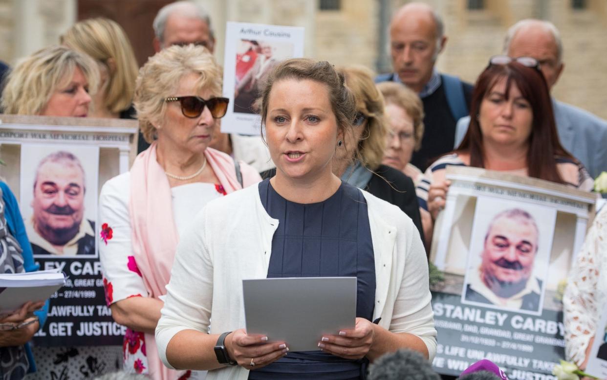 Bridget Reeves, the granddaugher of Elsie Devine, who died at Gosport, with other victims' relatives after the results of the inquiry were published - PA