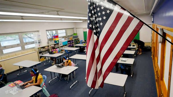 PHOTO: FILE - An American flag hangs in a classroom as students work on laptops in Newlon Elementary School, Aug. 25, 2020 in Denver. (David Zalubowski/AP, FILE)