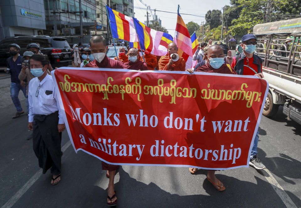 Buddhist monks march during a protest against the military coup in Yangon, Myanmar Tuesday, Feb. 16, 2021. Police in Myanmar have filed a new charge against ousted leader Aung San Suu Kyi, her lawyer said Tuesday, which may allow her to be held indefinitely without trial. (AP Photo)