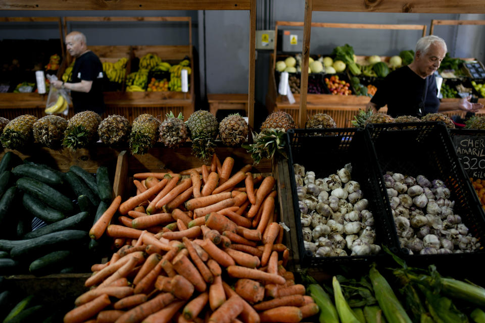 File - Shoppers buy vegetables in Buenos Aires, Argentina, Monday, Dec. 11, 2023. South America's second largest economy is suffering 143% annual inflation. (AP Photo/Natacha Pisarenko, File)