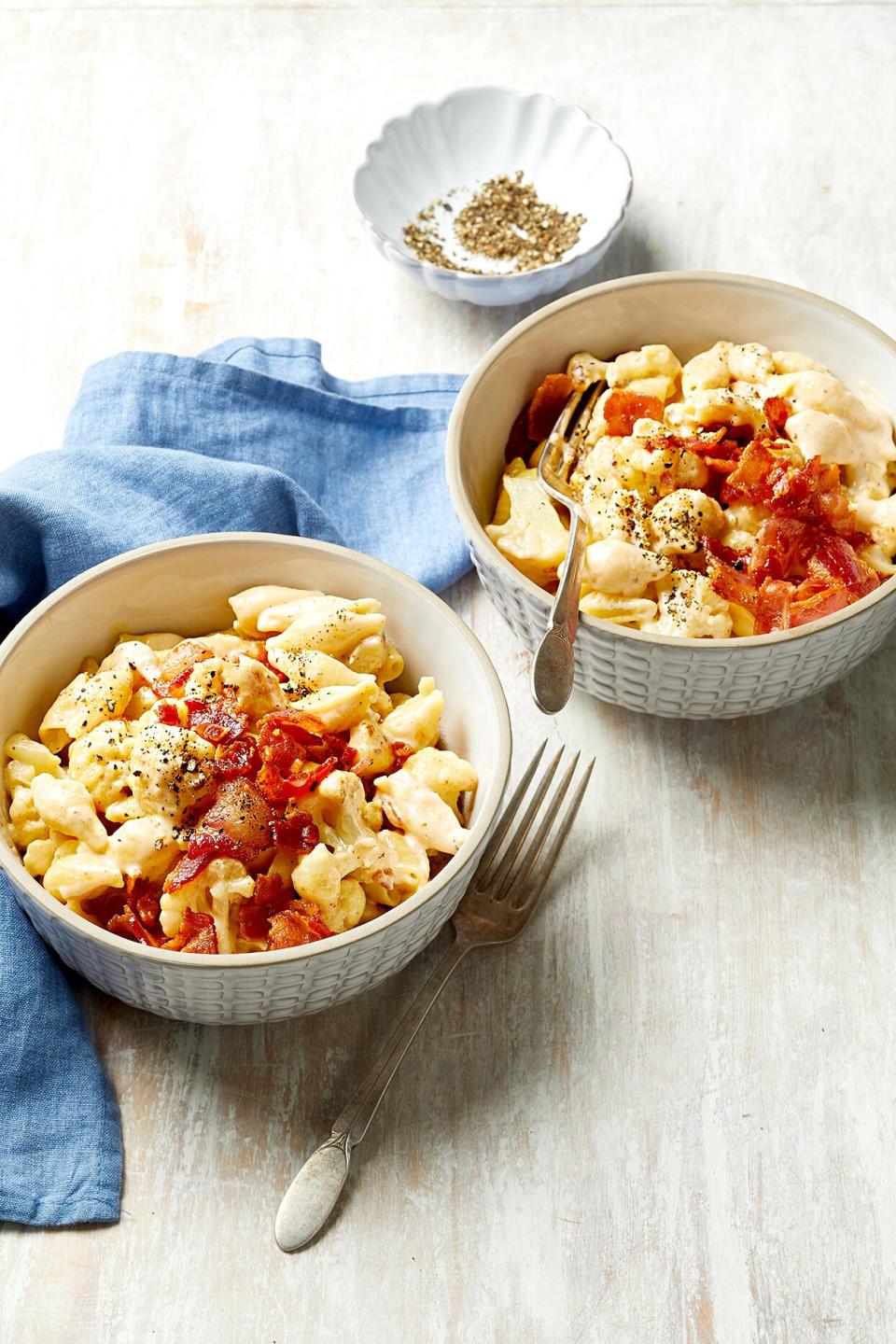 Cauliflower florets add a healthy punch to this one-pot dinner flavored with crispy bacon and a velvety two-cheese sauce.