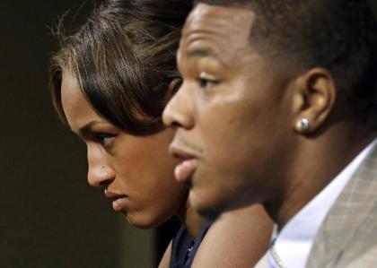 Janay Rice, left, looks on as her husband, Ray Rice, speaks to the media in September. (AP)