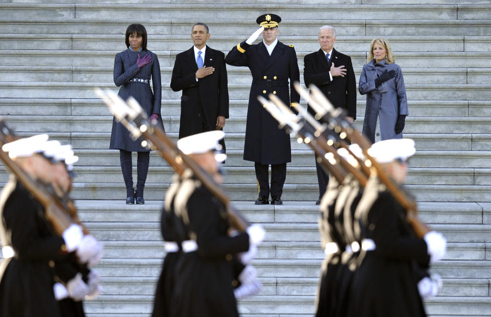 President Barack Obama, first lady Michele Obama, left, Army Major General Michael Linnington, Joint Forces Headquarters, National Capitol Region, center, and Vice President Joe Biden and his wife Jill Biden, place their hands over their hearts as they review the troops following his ceremonial swearing-in during the 57th Presidential Inauguration at the U.S. Capitol in Washington, Monday, Jan. 21, 2013. (AP Photo/Cliff Owen)