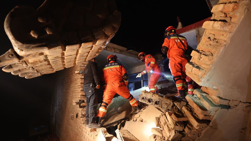 Rescuers search a crumbled house for survivors in Jishishan county, Gansu province on December 19, 2023. - Stringer/AFP/Getty Images