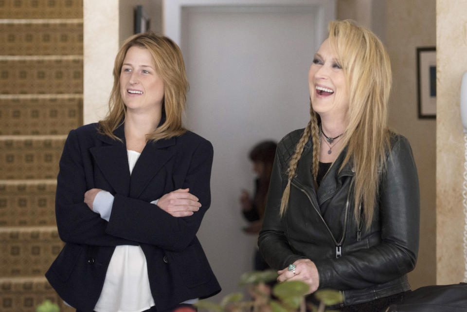 Meryl wearing a leather jacket and braids on one half of her hair while Mamie wears a blazer