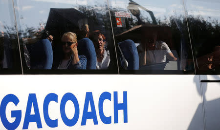 Some of the 36 Dutch tourists are seen on a bus ahead of their flight out of South Africa on Tuesday after they were robbed at gunpoint on Sunday in a brazen heist while traveling from JohannesburgÕs main international airport to their hotel, officials said, in Johanneburg, South Africa, September 26, 2017. REUTERS/Siphiwe Sibeko