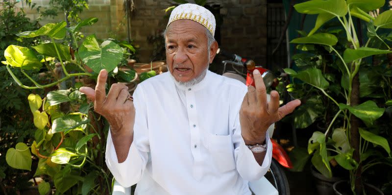 Mohammedi Durbar, 85, gestures as he speaks with Reuters at his farm on the outskirts of Karachi,