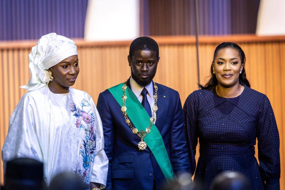 Bassirou Diomaye Faye with his wives Marie Khone Faye (L) and Absa Faye (R) at his swearing-in ceremony (AFP via Getty)