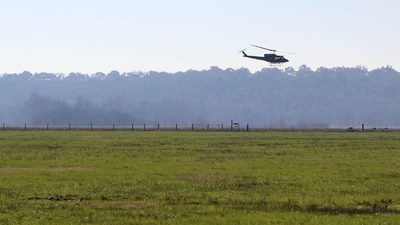 A HeliBacon helicopter hunts for feral hogs above farmland in Bryan