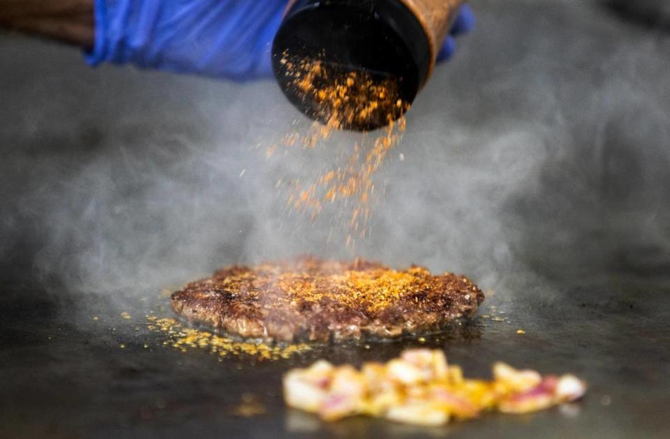 Juan Fernandez seasons a wagyu patty while grilling up burger in his mobile food truck, Sweet Sugar High, on Thursday, June 16, 2022. Sweet Sugar High won Star-Telegram Readers’ Choice Best Burger contest in the food truck category.