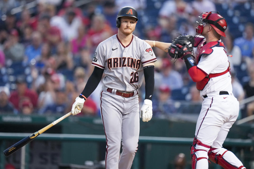 Arizona Diamondbacks' Pavin Smith reacts after striking out with Washington Nationals catcher Riley Adams nearby during the fifth inning of a baseball game at Nationals Park, Wednesday, June 7, 2023, in Washington. (AP Photo/Alex Brandon)