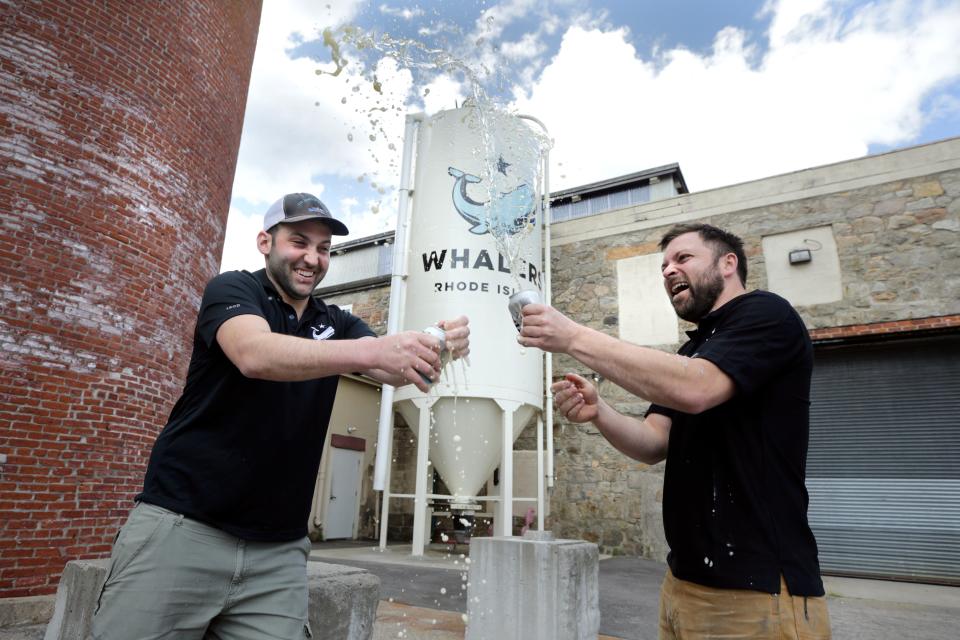 Co-owners Josh Dunlap and Wes Staschke of Whaler's Brewing salute their customers with a shaken beer toast at their South Kingstown facility.