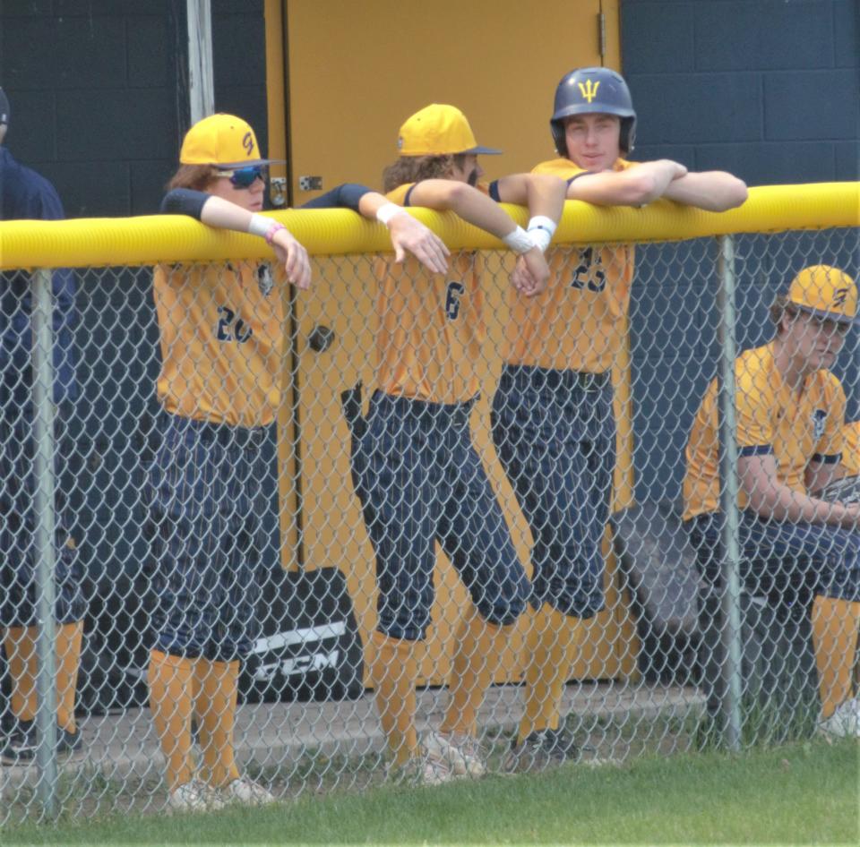 Isaac Hopp (left), Lucas Green (center) and Luke Enders (right) talk between innings during a high school baseball matchup between Gaylord and Charlevoix on Thursday, May 18.