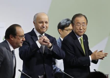 French President Francois Hollande (L) takes his seat at a plenary session with Foreign Affairs Minister Laurent Fabius (C), President-designate of COP21, who clenches his hands, and United Nations Secretary-General Ban Ki-moon at the World Climate Change Conference 2015 (COP21) at Le Bourget, near Paris, France, December 12, 2015. REUTERS/Stephane Mahe