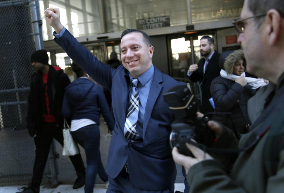 Johnny Hincapie raises his fist as he leaves the courthouse in New York, Wednesday, Jan. 25, 2017. Prosecutors dropped a case Wednesday against Hincapie, who spent a quarter-century behind bars in an infamous tourist killing before getting his conviction overturned. (AP Photo/Seth Wenig)
