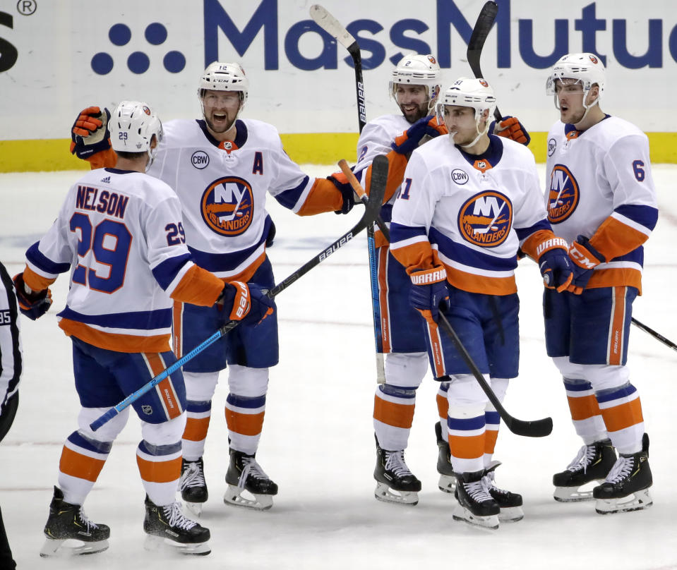 New York Islanders' Josh Bailey (12) celebrates his empty-net goal against the Pittsburgh Penguins during the third period in Game 4 of an NHL hockey first-round playoff series in Pittsburgh, Tuesday, April 16, 2019. The Islanders won 3-1, sweeping the series. (AP Photo/Gene J. Puskar)