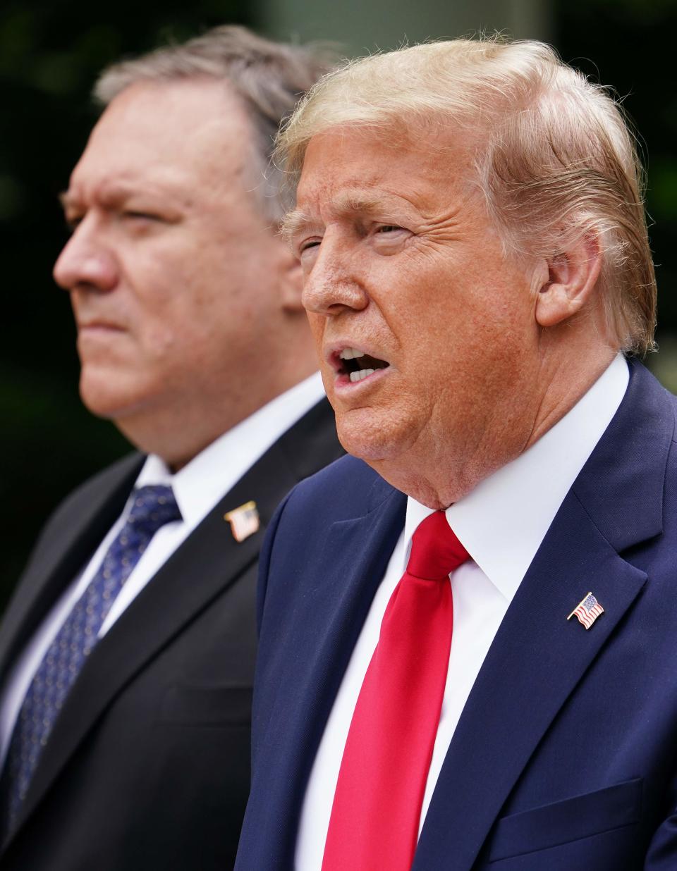 U.S. Secretary of State Mike Pompeo looks on as President Donald Trump speaks during a press conference on China in the Rose Garden of the White House on May 29.