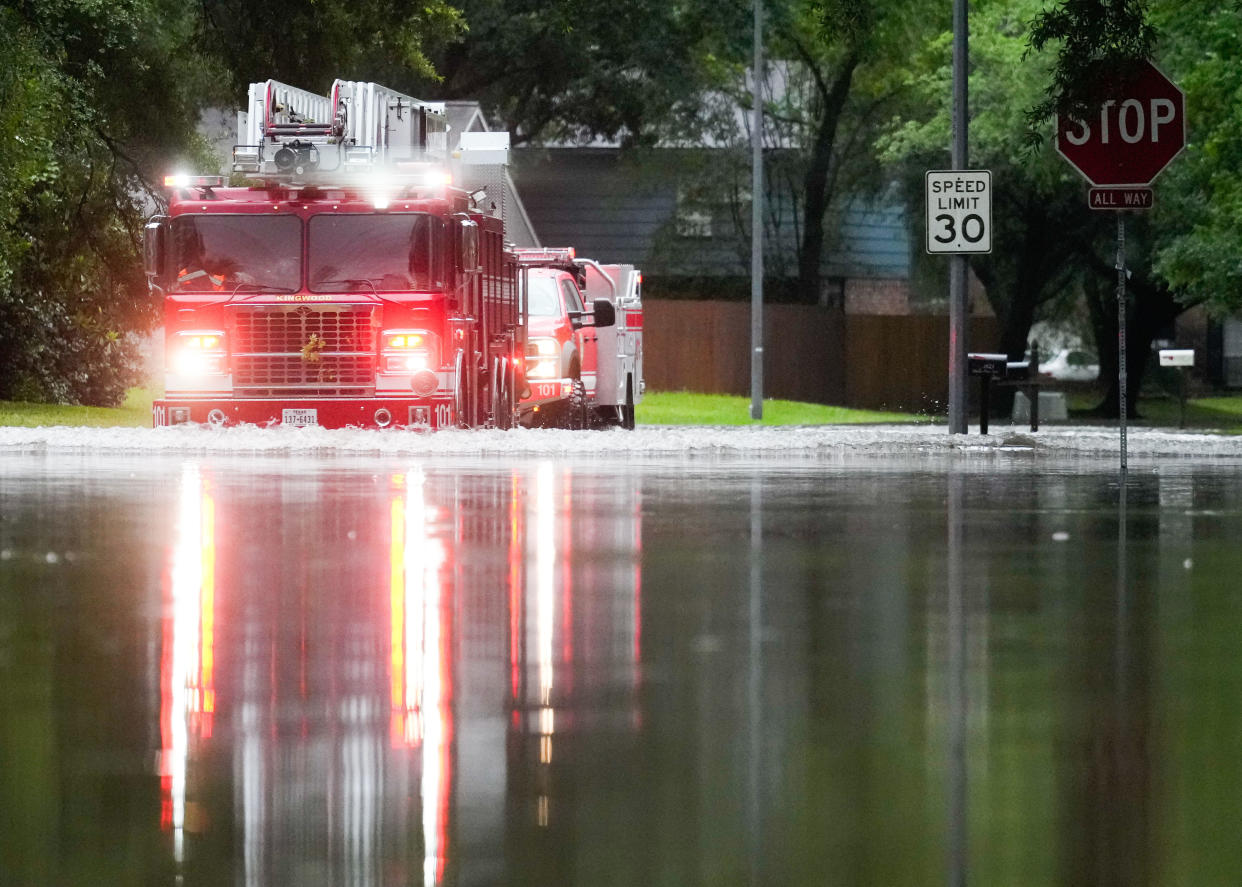 A Houston firetruck makes it way through flood water after severe flooding. / Credit: Houston Chronicle/Hearst Newspap