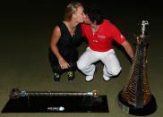 DUBAI, UNITED ARAB EMIRATES - NOVEMBER 25: Rory McIlroy of Northern Ireland poses alongside his girlfriend Caroline Wozniacki with both the Race To Dubai and DP World Tour Championship trophies after winning the DP World Tour Championship on the Earth Course at Jumeirah Golf Estates on November 25, 2012 in Dubai, United Arab Emirates. (Photo by Andrew Redington/Getty Images)