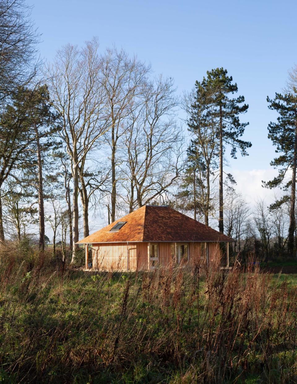 Material Cultures used air-dried hempcrete (a bio-composite of hemp and a lime-based binder) for this roughly 970-square-foot residential build. Locally sourced timber and wood-fiber insulation are also among the materials used. A rainscreen cladding of larch, also locally sourced, is situated beneath the eaves of the shingled roof.