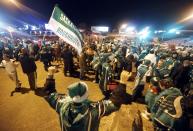 A Saskatchewan Roughriders fans celebrate after their team beat the Hamilton Tiger-Cats in the CFL's 101st Grey Cup championship football game in Regina, Saskatchewan November 24, 2013. REUTERS/David Stobbe (CANADA - Tags: SPORT FOOTBALL)