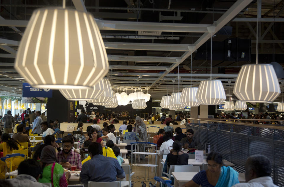 FILE- In this Aug. 9, 2018, file photo, customers sit at the restaurant inside Ikea's's first store in India as it opened in Hyderabad, India. In Hyderabad’s bustling Nampally furniture market, customers explore a crowded labyrinth of shops, haggle over prices and work with carpenters to design made-to-order housewares. This is the competition Swedish giant Ikea faces in tackling the $40 billion Indian market for home furnishings, which is growing quickly along with the country’s consumer class. (AP Photo/Mahesh Kumar A, file)