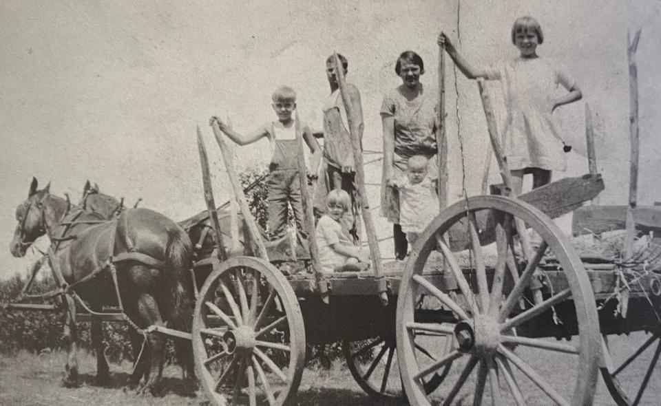 Axel and Ida Tuomi are pictured on their horse-drawn wagon with daughters Irene, Lili and Lempi. The young hired boy to the left is believed to be the Tuomi's nephew Paul Ilves.