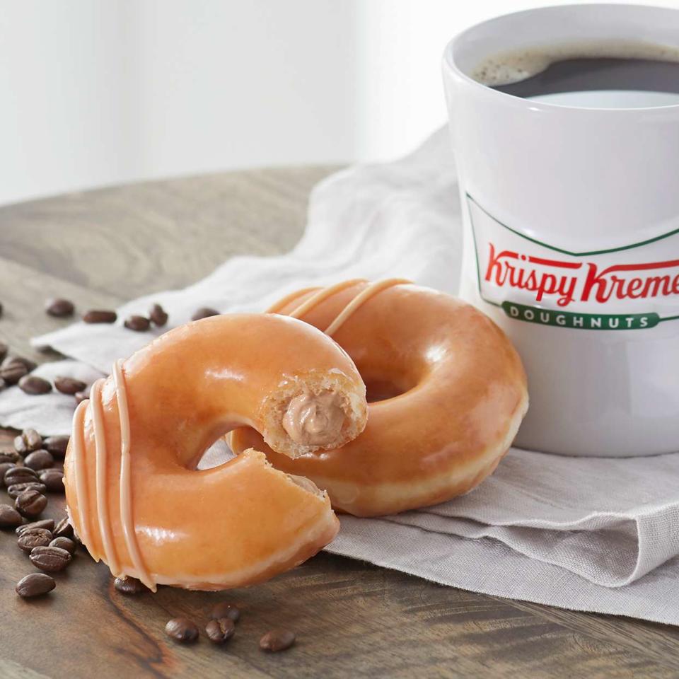 Original Filled Coffee Kreme donut on tabletop with coffee in background