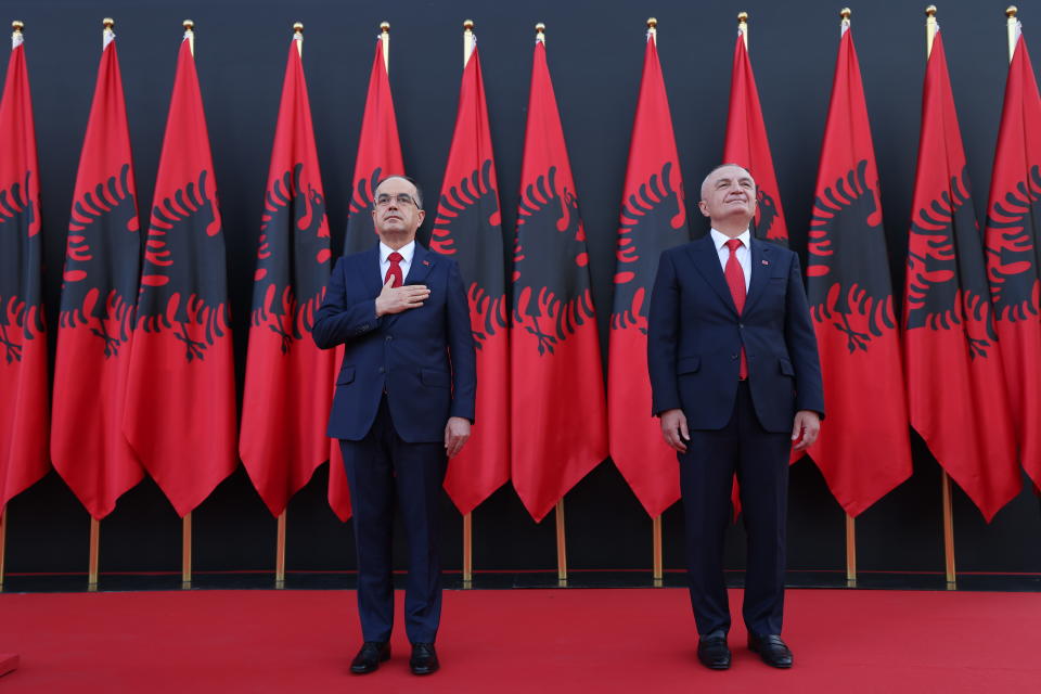 Newly appointed Albanian President Bajram Begaj, left, stands next to former President Ilir Meta, during an inauguration ceremony at the Presidential palace, in Tirana, Sunday, July 24, 2022. Albania's new president sworn in on Sunday calling on the country's political parties to cooperate and consolidate the rule of law. (AP Photo/Franc Zhurda)