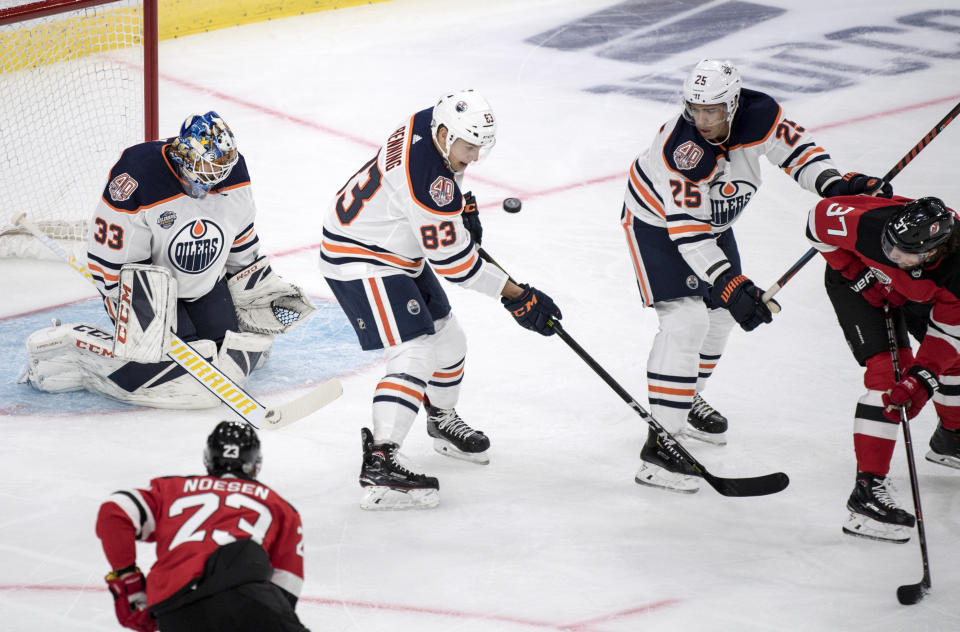 Edmonton Oilers' Matt Benning blocks a shot in front of Edmontons' goalie Cam Talbo , during the season-opening NHL Global Series hockey match between Edmonton Oilers and New Jersey Devils at Scandinavium in Gothenburg, Sweden, Saturday, Oct. 6, 2018, (Bjorn Larsson Rosvall /TT News Agency via AP)