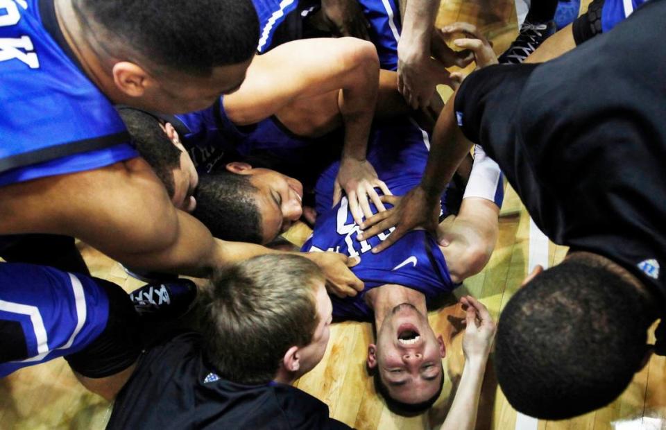 Duke guard Austin Rivers (0) is mobbed by teammates after hitting a three pointer as time expired to beat UNC 85-84. Duke battled UNC at the Smith Center in Chapel Hill, N.C. Wednesday, Feb. 8, 2012.