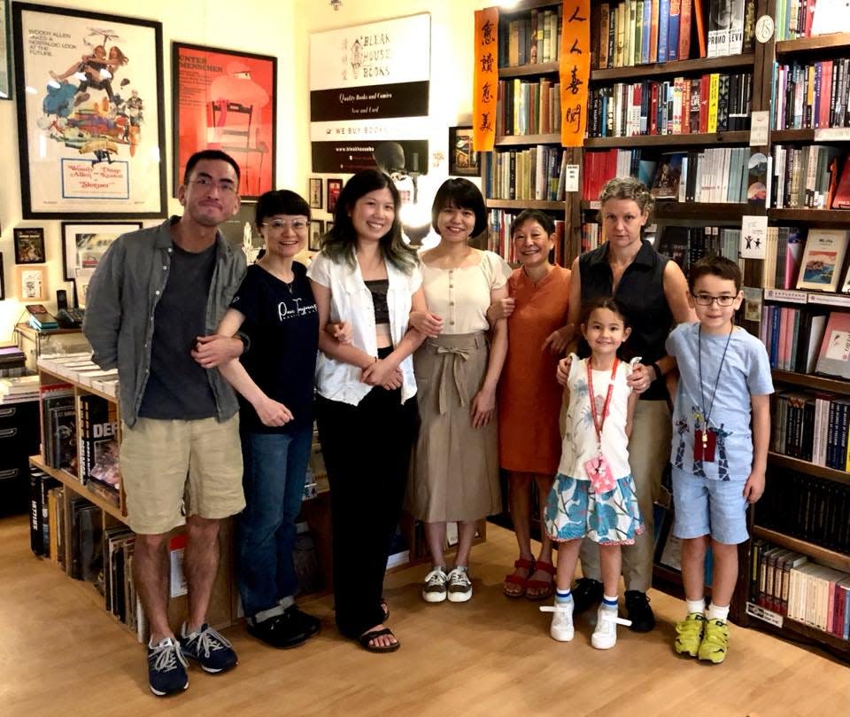 Albert Wan, at left, and Jenny Smith, at right, with their children and others at the original Bleak House Books location in Hong Kong.