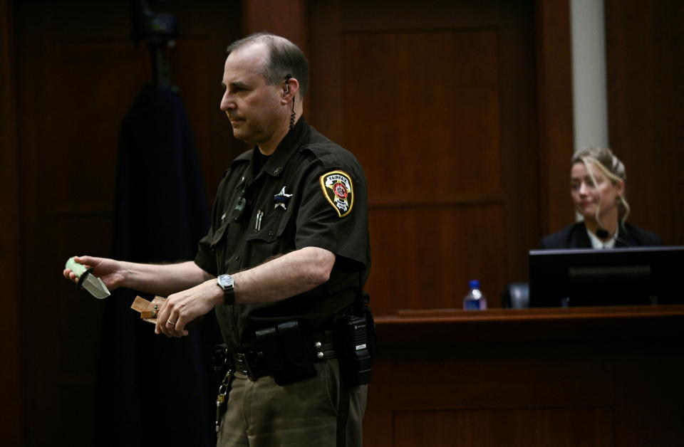 A Fairfax County Deputy Sheriff holds the knife that actor Amber Heard gifted to Johnny Depp in 2012