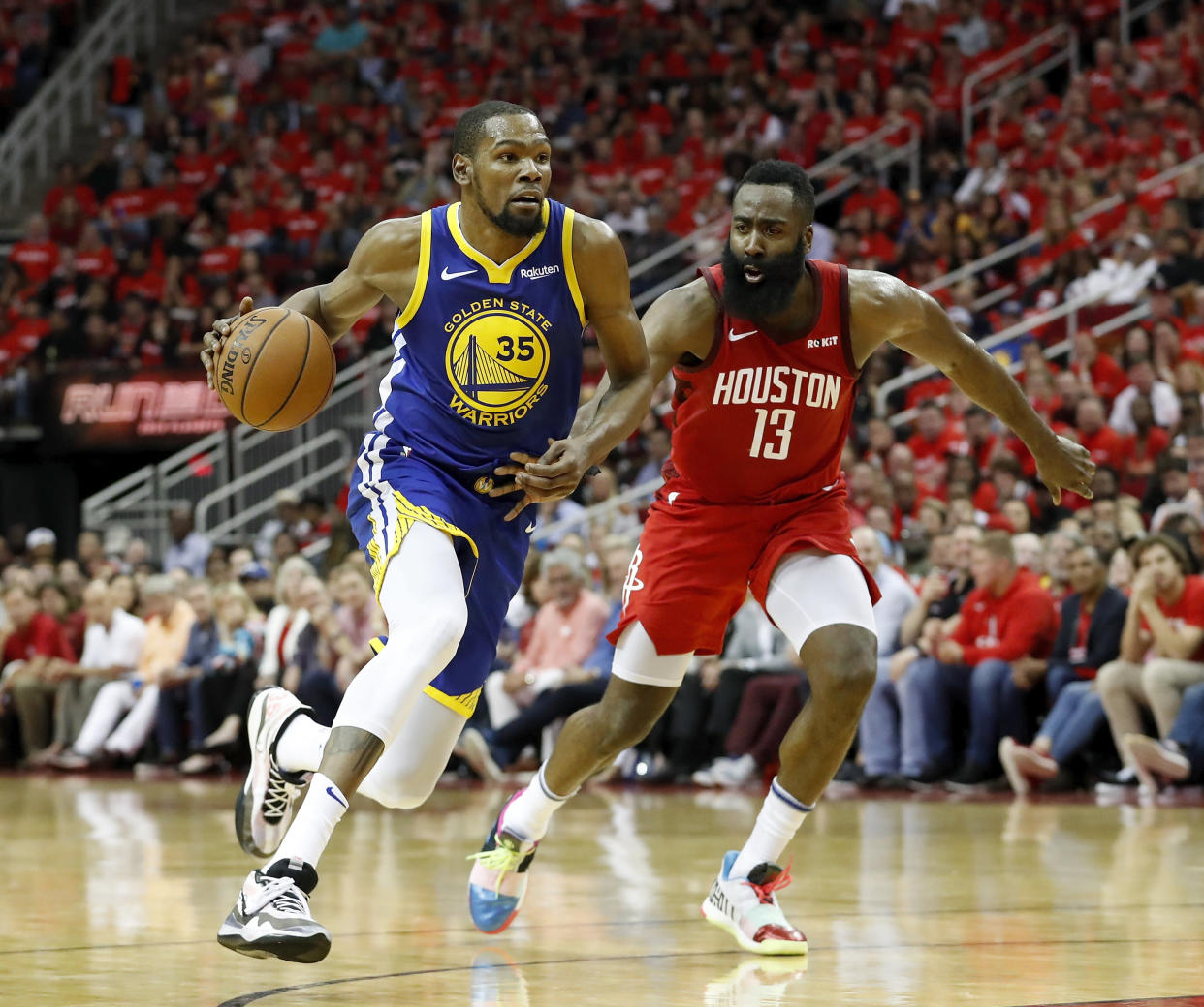 Kevin Durant and James Harden remained on the court after a collision left both stars ailing. (Getty)