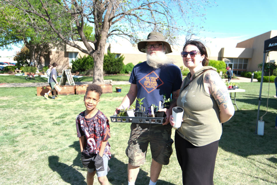 A family shows off their plant purchase at the Randall County Master Gardeners plant sale Saturday as part of Gardenfest at the Texas A&M AgriLife Extension Center in Amarillo.