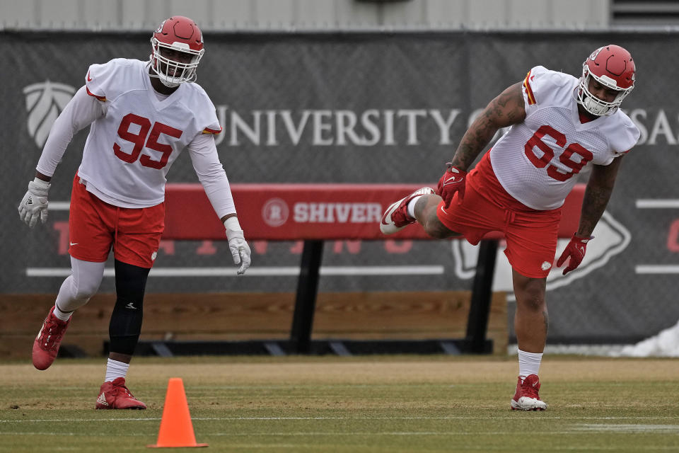 Kansas City Chiefs defensive tackles Chris Jones (95) and Mike Pennel Jr. (69) stretch during the NFL football team's practice Friday, Jan. 26, 2024, in Kansas City, Mo. (AP Photo/Charlie Riedel)